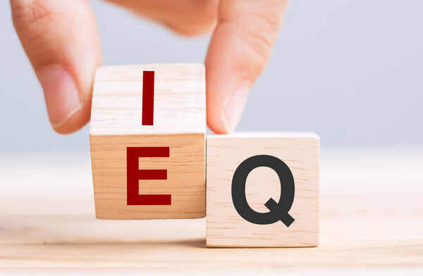 Business man hand change wooden cube block from IQ to EQ, balance between intelligence quotient and emotional intelligence concepts